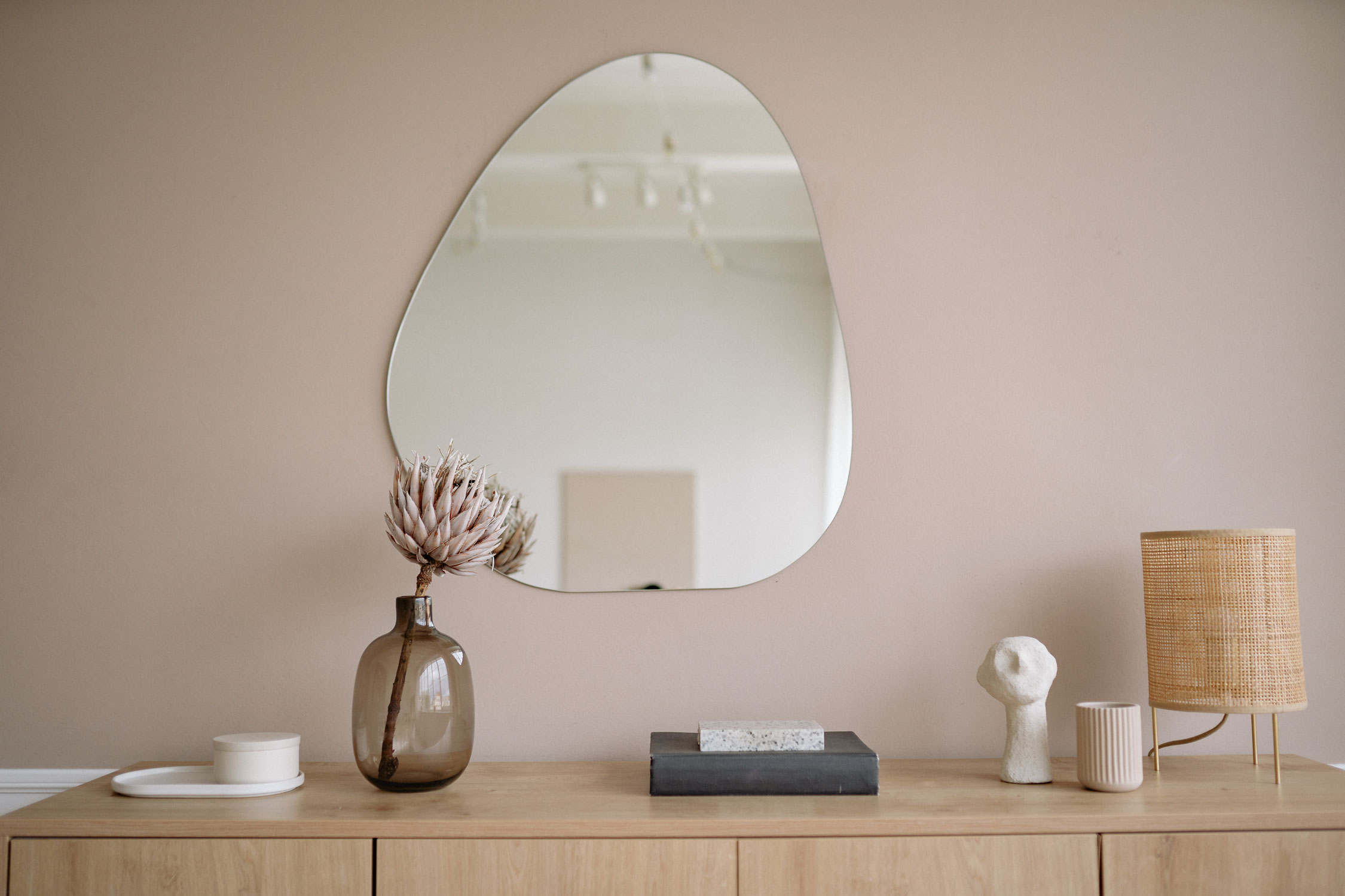 Minimalist interior with mirror and decorative items.