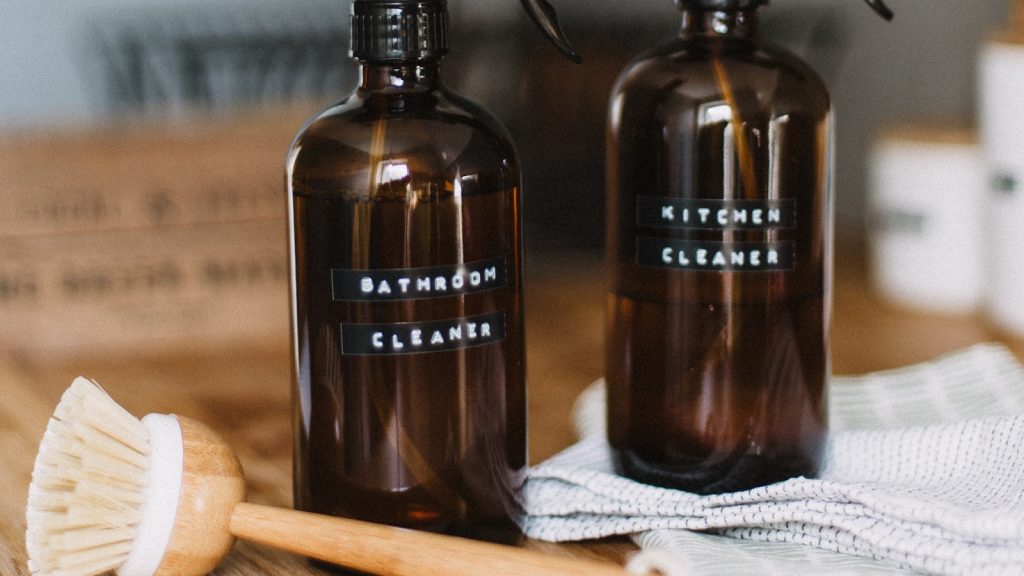 Refillable amber spray bottles used for non-toxic home cleaning.